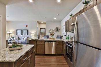 A kitchen with stainless steel appliances and granite counter tops